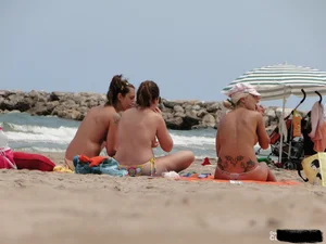 Tattooed blonde with big tits topless and in thong