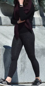 Brunette with glasses on the phone in tight patterned leggings