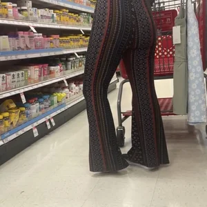 White girl in flare pants bending over