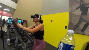 Smoking hot brunette working out at the gym in tight leggings