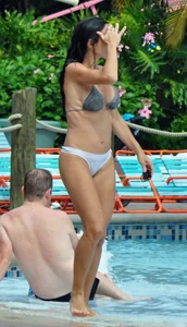 Sexy brunette lady with nice tits at the pool in a semi thong bikini