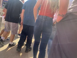 Bunch of girls in various outfits at a Cardinals baseball game