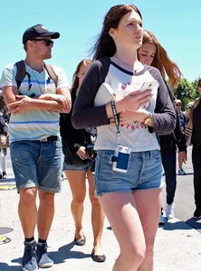 Cute girl walking in short jean shorts