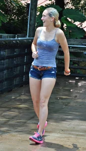 Cute blonde in denim shorts and a wet top