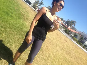 Hot brunette babe in leggings walking her dog with a nice ass and some cleavage