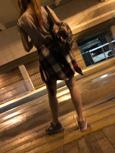 Cute Teen in Shorts on the Tram Stop