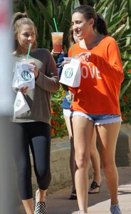 Brunette in tiny shorts walking with her sexy friend in leggings