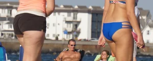 Beach babe in a blue bikini with thick friend in shorts