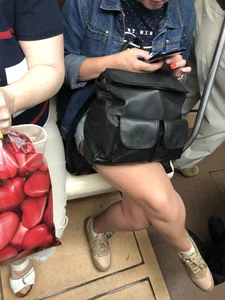 Hot crossed legs closeups in a subway train