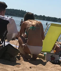 Swedish beach blonde girl in white and green bikini