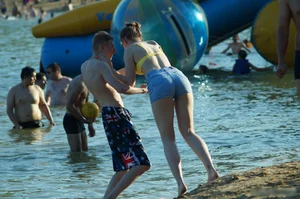 Hot Girl in Swimsuit Top and Denim Shorts by the Water on the Beach Creepshots