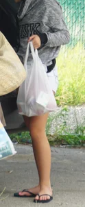 Girl next door teen neighbor bringing in groceries in short jean shorts