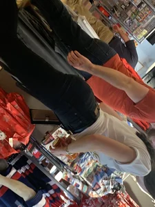 Bunch of girls in various outfits at a Cardinals baseball game