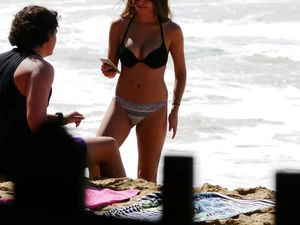 Sexy ass brunette with a perfect body in bikini on the beach