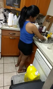Asian girlfriend doing dishes in spandex shorts