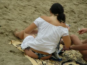 Sexy girl in a blue floral thong bikini at the beach