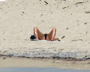 Small boobed topless milf on the beach