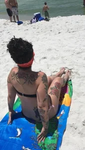 Tattooed Girl Sitting on the Beach Creepshot