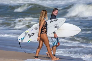 Candid girls surfing on the beach