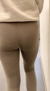 Following the blonde with Fake lashes in green leggings