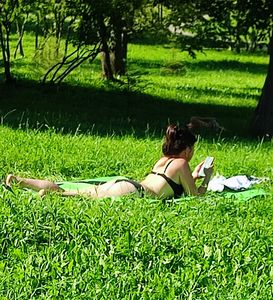 Milf laying on the grass in the park, cameltoe creepshots