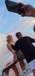 Blonde bending over on a boat in leggings