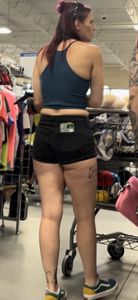 Tattooed girl with pierced nips and cheeks hanging out